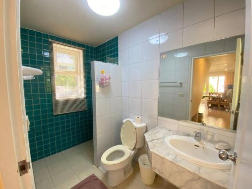 a bathroom with a toilet and a sink at Baan Talay Samran B4/12D in Ban Khlong Khot