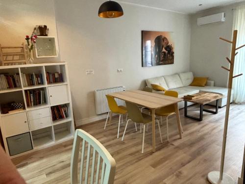 a living room with a table and a couch at PRECIOUS AND ORIGINAL APARTMENT CENTER in Cádiz