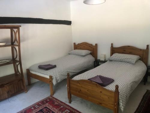 two twin beds in a room with a shelf at The Star in Lydd