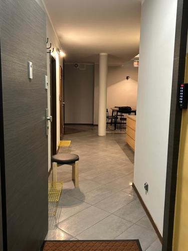a hallway with a table and chairs in a room at Nad rzeką XL Luxury in Piła