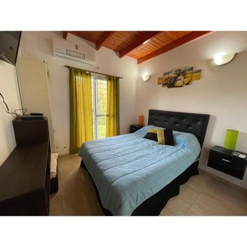 a bedroom with a bed with a blue comforter at Caggdom in Salvador María