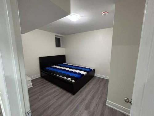 a room with a black and blue bed in a room at 2 Bedroom private apartment with private entrance in Brampton