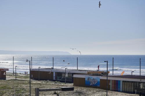 a view of a beach with the ocean at Stunning Beach Sunset View, By TimeCooler in Costa da Caparica