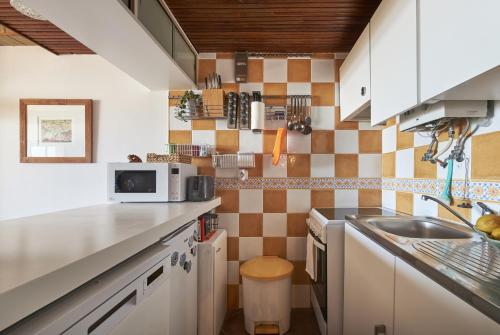 a kitchen with a sink and a counter top at Stunning Beach Sunset View, By TimeCooler in Costa da Caparica