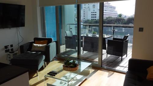 a living room with a view of a balcony at Gibraltar Luxury with Rooftop Pools & Views in Gibraltar