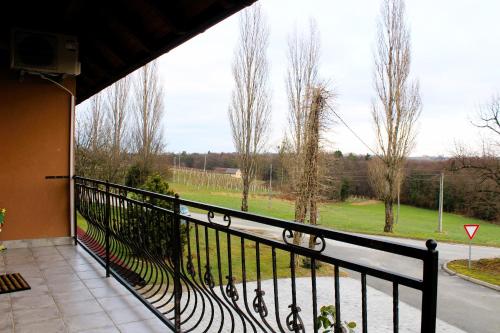 a balcony with a view of a street and trees at POČITNIŠKA HIŠA SONČNI VRH in Spodnji Ivanjci