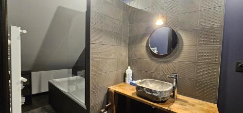 a bathroom with a sink and a mirror at PADDOCK 24 Arnage - Loft Le Mans in Arnage