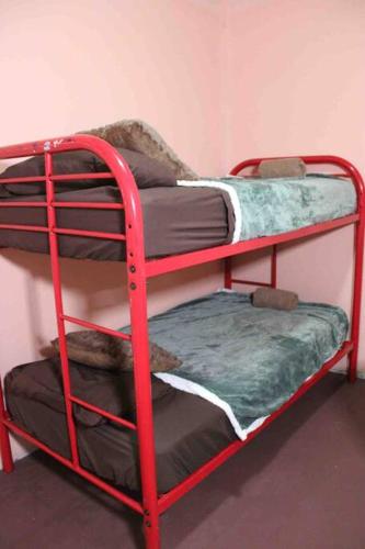 two red bunk beds in a room at Casa LUNA in Boquete