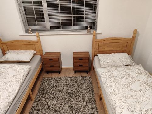 two twin beds in a room with a window at Perfect Place in Walsall/ 4 bedroom / long term workers or family home in Walsall