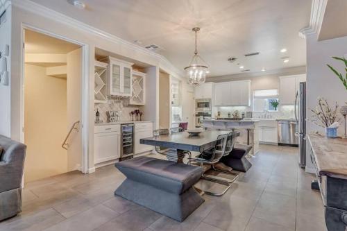 a large kitchen with a dining table and chairs at 4BR Spectacular Harbor View Modern Home 5min Zoo in San Diego