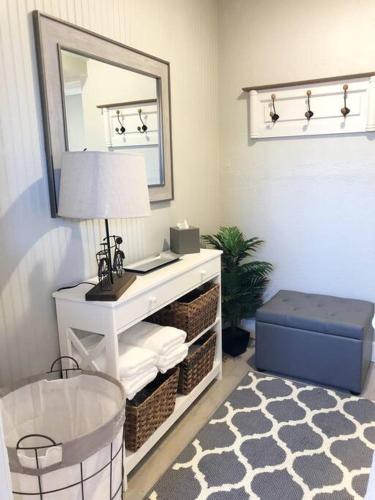 a room with a white table with a mirror and a stool at Cozy Apartment Overlooking Downtown and Park NO KIDS, NO PETS in Dunedin