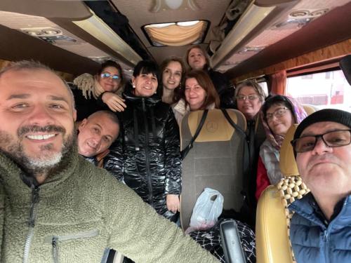 a group of people posing for a picture on a bus at GIADDA Rooms in Borşa