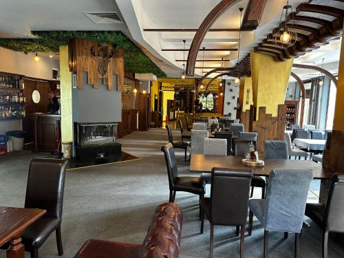 a restaurant with tables and chairs and a fireplace at Borovets Holiday Apartments - Different Locations in Borovets in Borovets