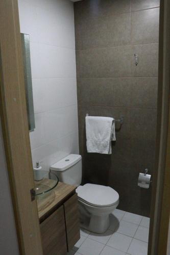 a bathroom with a toilet and a sink at Aparta Estudio Norte Bogotá in Bogotá
