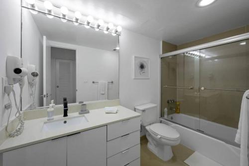 a bathroom with a sink and a toilet and a shower at Ocean View 15th floor Apartment Sunny Isles in Sunny Isles Beach