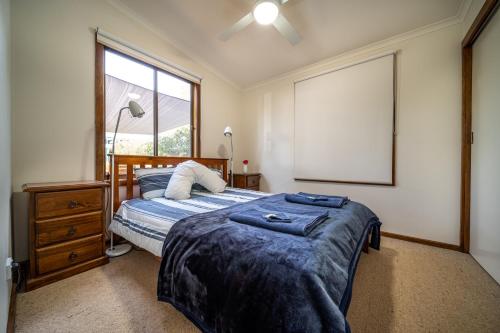 a bedroom with a bed and a window at Flinders Ranges Bed and Breakfast in Hawker