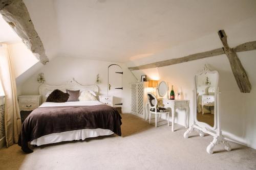 a bedroom with a white bed and a desk at Sheene Mill in Melbourn