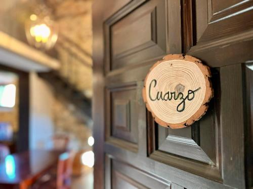 a door with a sign that says cancer on it at El Bulín de Patones in Patones