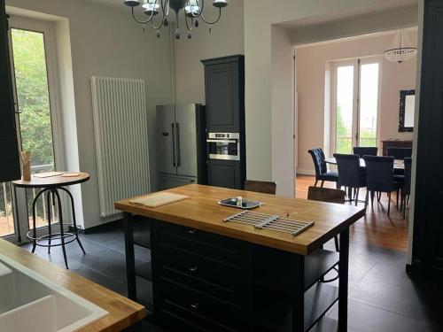 a kitchen and dining room with a table and chairs at Villa Morton - Domaine du Grand Tourmalet Pic du Midi in Bagnères-de-Bigorre