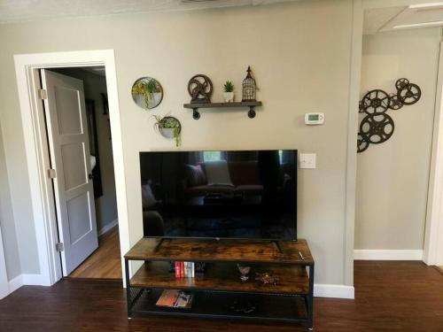 a living room with a flat screen tv at The Nest Downtown Dunedin NO KIDS, NO PETS in Dunedin
