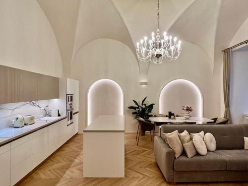 a kitchen and living room with a couch and a table at Arch IV. in Prague