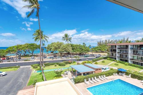an aerial view of a resort with a pool and a parking lot at Maui Parkshore 410 - Stunning Ocean Views in Wailea
