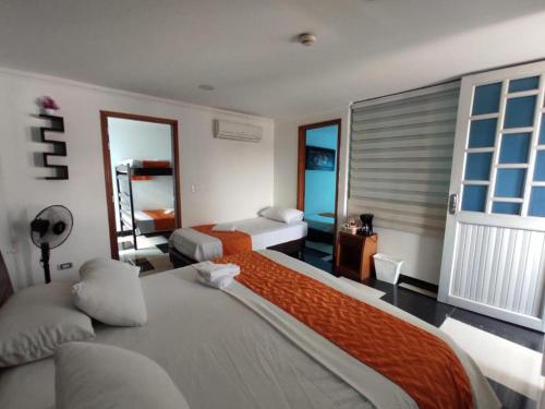 a hotel room with a large bed and a window at Apartamento Villa llano in Villavicencio