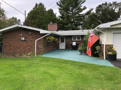 a brick house with a flag in a yard at Cliff’s Place in Iron Bridge