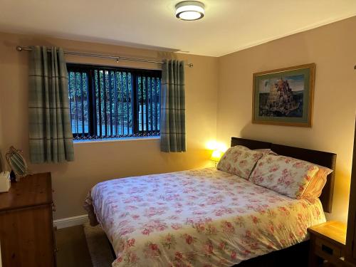 a bedroom with a bed and two windows at Beechcroft Corner House in Ecclesall