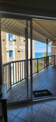 a balcony with a view of the ocean at 11 Seesonnet beach flat in Scottburgh
