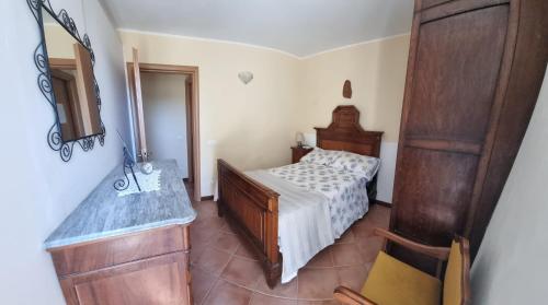 a bedroom with a bed and a dresser and a mirror at Casa Vacanze AL TEATRO in Diano Castello