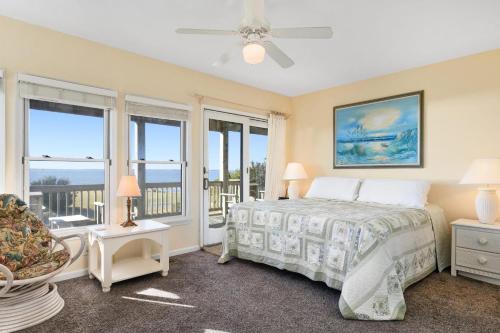 a bedroom with a bed and a balcony at B20 Bay Meadow 20 in Nags Head