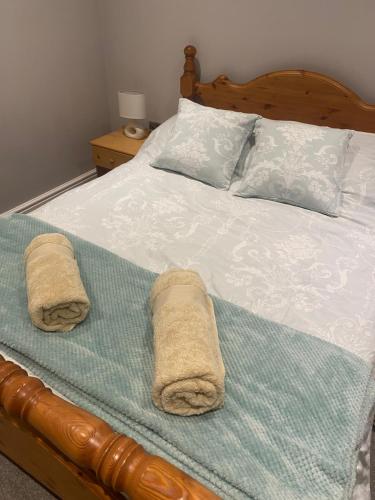 a bedroom with a bed with towels on it at The Annexe in Middleham