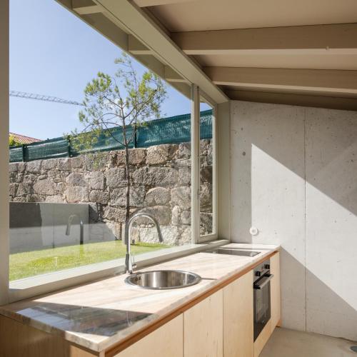 a kitchen with a sink in front of a window at L'Olivier 23 - 2 apartments in a recently renovated Guesthouse in Porto