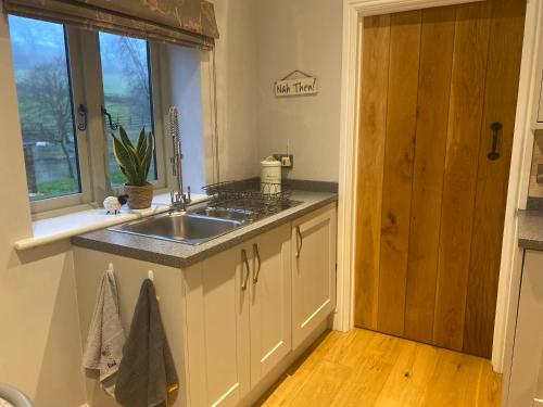 a kitchen with a sink and a window at The Annexe in Middleham