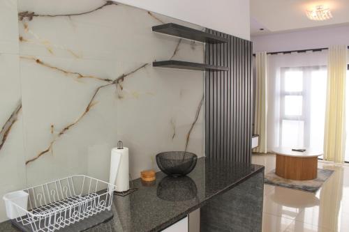 a kitchen with a counter with a marble wall at Deluxe Residence - Windhoek in Windhoek