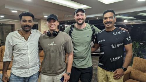 a group of three men posing for a picture at Dreams Paradise Airport Residency in Nedumbassery