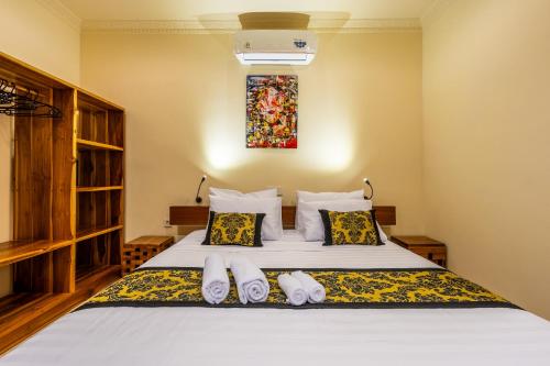 a bedroom with a bed with white sheets and pillows at Paradise Villa Gili Air in Gili Air