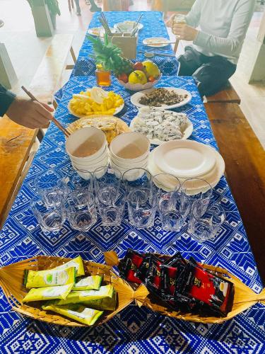 a table with a blue and white table cloth with food at Homestay Chinh Bi in Yên Bái