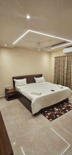 a bedroom with a large bed in a room at HOTEL VAISHNO AEROCITY in Bhubaneshwar