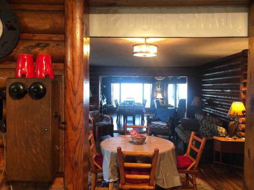 a dining room with a table and a living room at The Huron Hutch in Evergreen Shores
