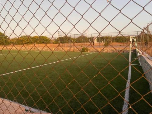 a baseball field behind a chain link fence at Casa Condominio en Tongoy cercano a puerto Velero in Tongoy