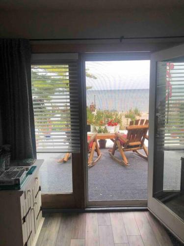 a room with a sliding glass door leading to a patio at The Huron Hutch in Evergreen Shores