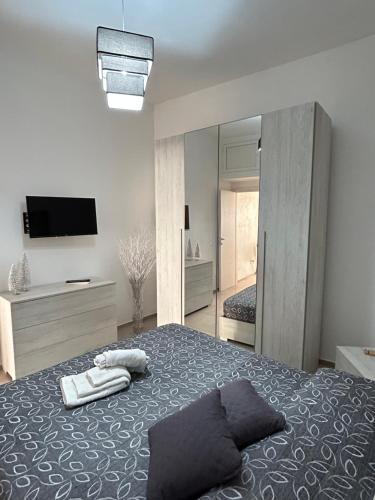 a bedroom with a bed and a large mirror at La Cupola - casa vacanze n 8 in Termini Imerese