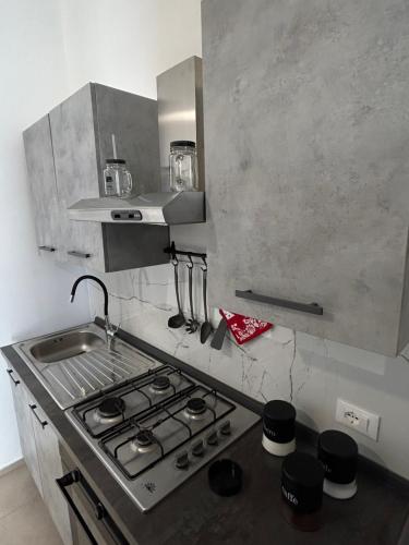 a small kitchen with a stove and a sink at La Cupola - casa vacanze in Termini Imerese