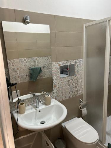 a bathroom with a sink and a toilet at La Cupola - casa vacanze in Termini Imerese