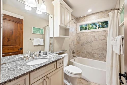 a bathroom with a sink and a tub and a toilet at 480 Fiddlers Reach in Kiawah Island