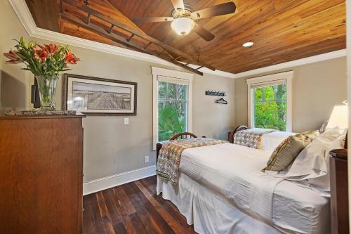 a bedroom with two beds and a ceiling fan at 480 Fiddlers Reach in Kiawah Island