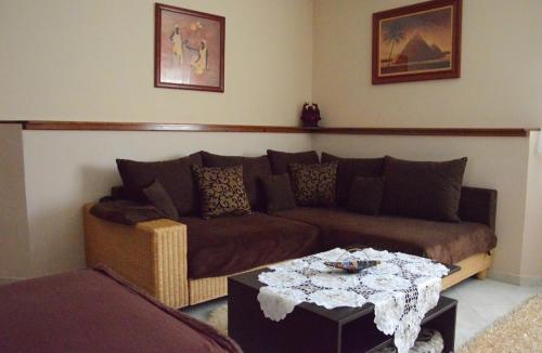 a living room with a couch and a table at Villa Csilla elegant house in Érd