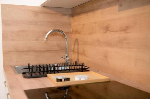 a kitchen with a sink with a faucet at Entire Tulum Apartment, in the Center of Vienna in Vienna